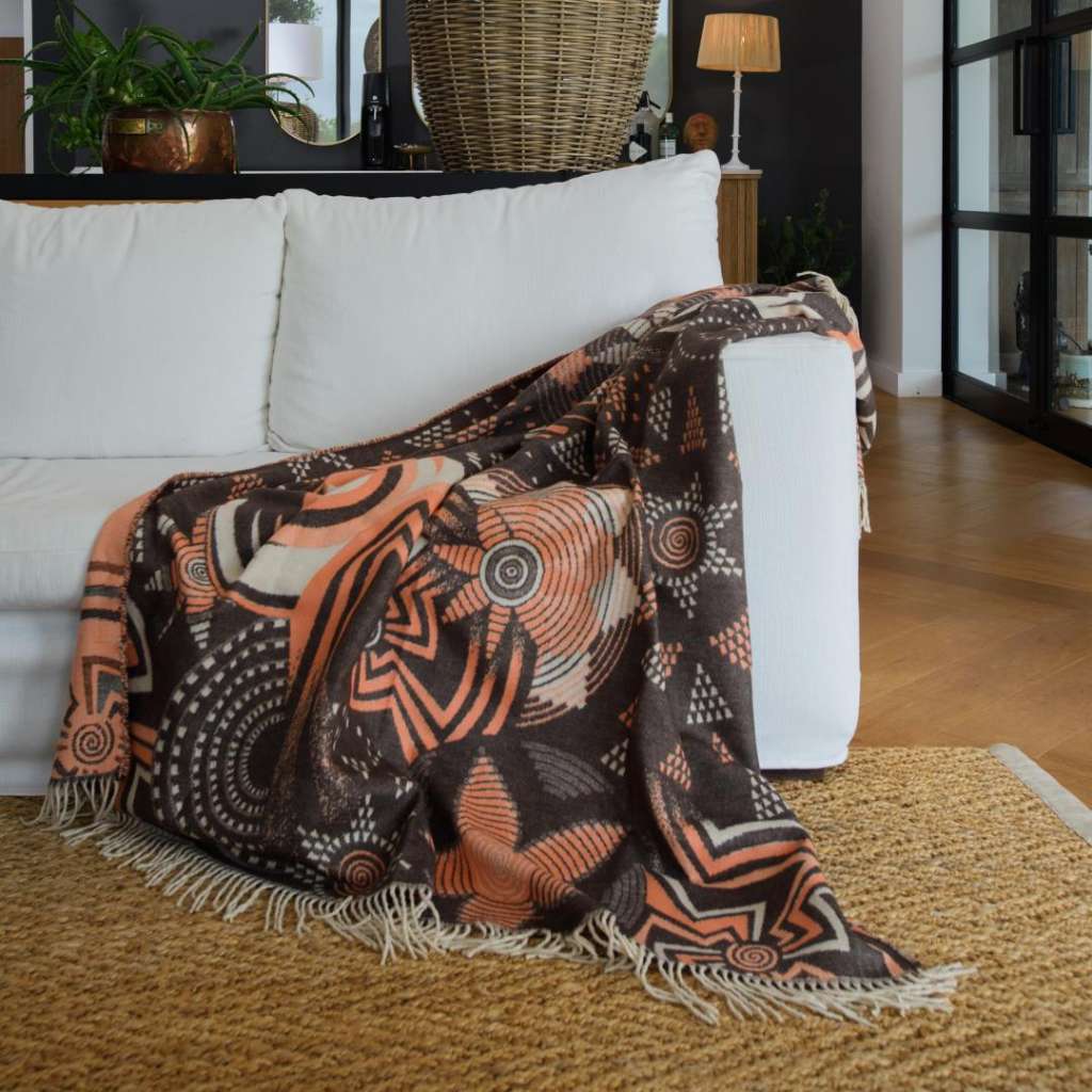 Lifestyle view of the Rwanda Throw Cocoa/Firecracker